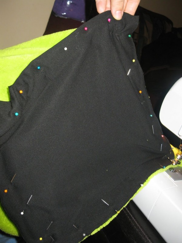 Black fabric is pinned to the fleece to create the mouth of the Yip Yip.