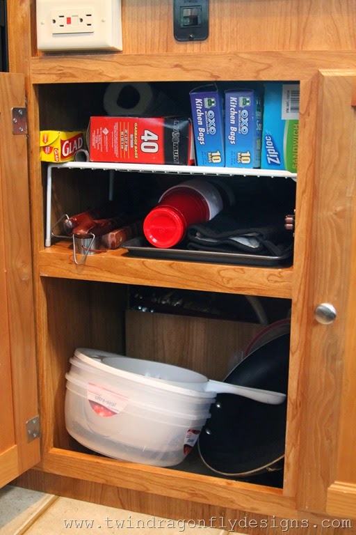 Wire dish organizer is used to organize Travel Trailer cupboards.