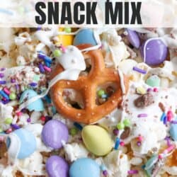 Close-up of a colorful Easter popcorn snack mix, featuring popcorn, pastel chocolate candies, pretzels, and sprinkles, with hints of chocolate coconut date bars. A text overlay reads Easter Popcorn Snack Mix.