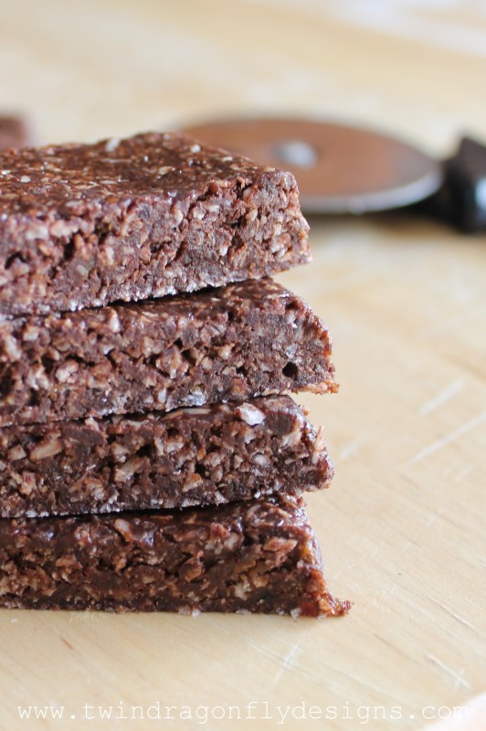 Chocolate Coconut Date Bars stacked on top of each other.