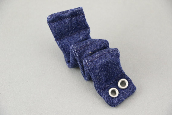20+ Sensory Crafts for Kids A worm made from fabric and magnets on a plain surface.