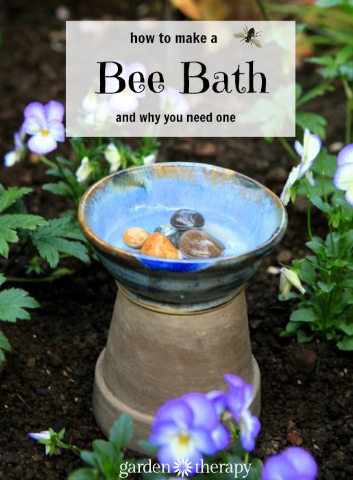 Bee bath made of old pots with pansies in the background.