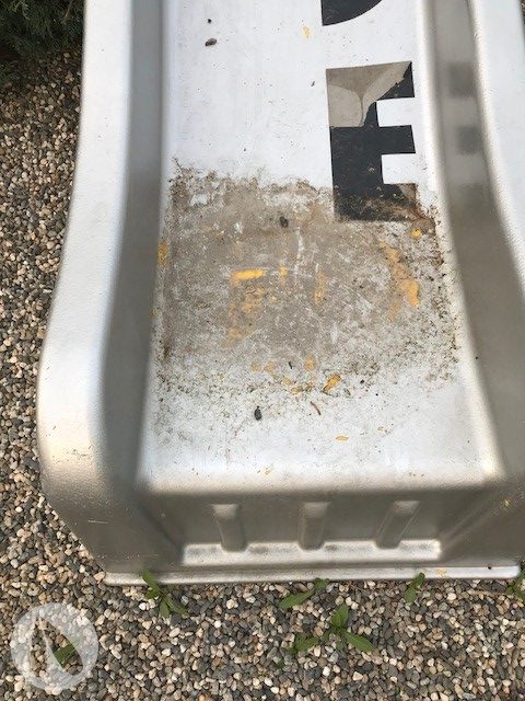 The paint on the slide starting to crack at the bottom where the water and dirt pool.