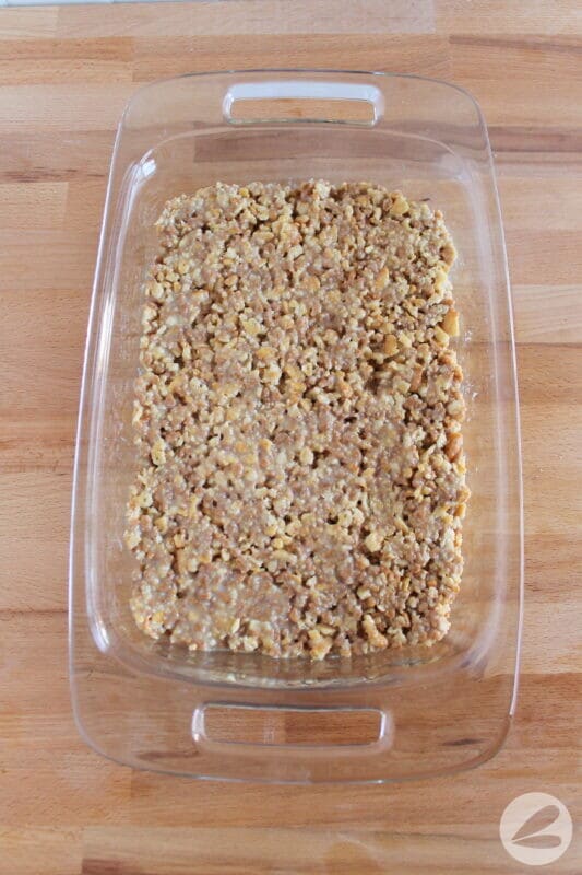 The white trash bar base ingredients are pressed into a baking pan.