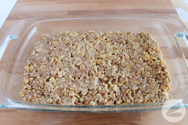 The bar ingredients are pressed into a baking pan.