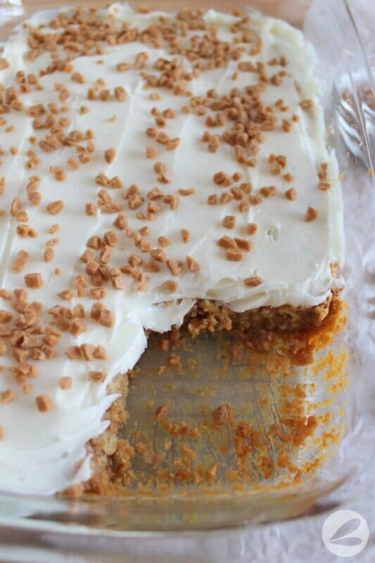 A close up of the pan with one of the squares removed from the white trash bar recipe.