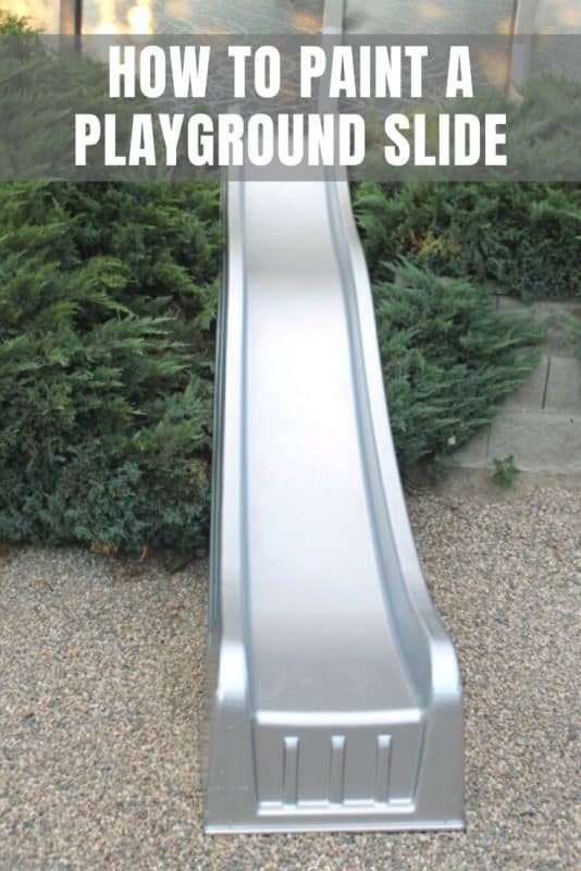 A painted playground slide in a back yard.