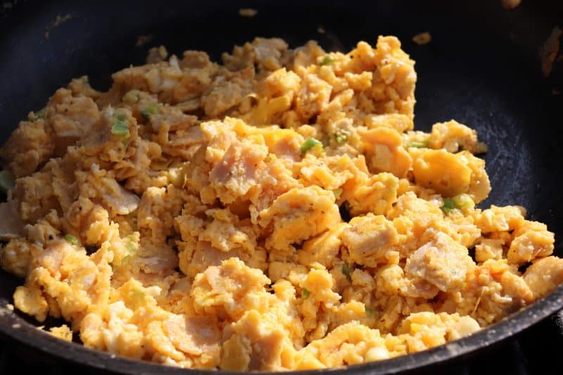Cooked scrambled eggs in a skillet.