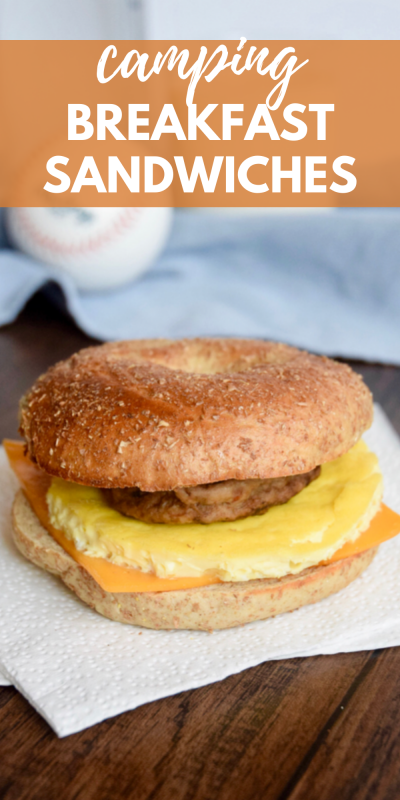 Breakfast sandwich made of a sliced bagel with a sausage pattie, cooked egg and a slice of processed cheese in the middle on a white napkin with text overlay.