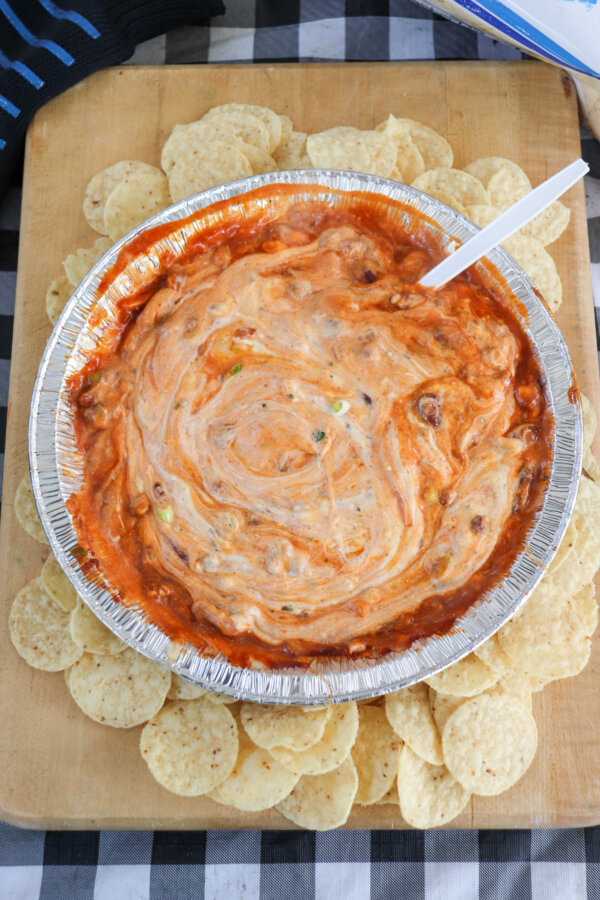 Chili topped with cream cheese , swirled with melted cheese, surrounded by tortilla chips in a foil packet.