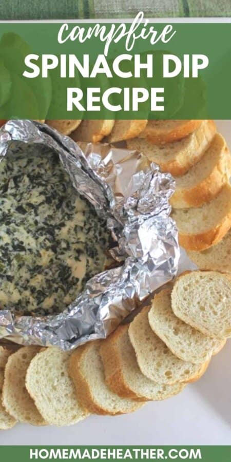 Campfire Spinach Dip in a foil packet surrounded by slices of baguette on a white plate with text overlay.