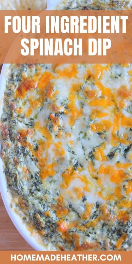 Four ingredient cheesy spinach dip in a baking dish on a wooden surface.