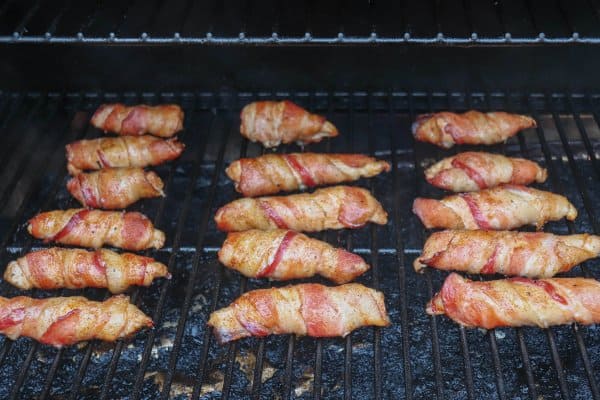 Easy Bacon Wrapped Chicken Tenders A grill full of chicken tenders wrapped in bacon.