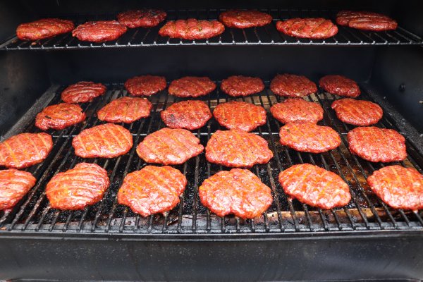 Smoked Burgers on the grill grates of a Traeger grill.