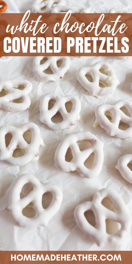 White chocolate covered pretzels on a parchment paper covered tray.