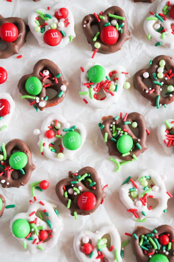 Christmas chocolate covered pretzels with green and red sprinkles and M&Ms.