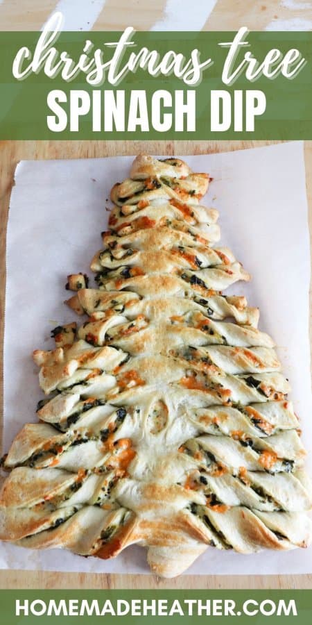 Spinach dip bread sticks in the shape of a Christmas tree in a parchment paper lined wooden cutting board.