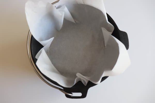 Cast iron dutch oven lined with parchment paper.