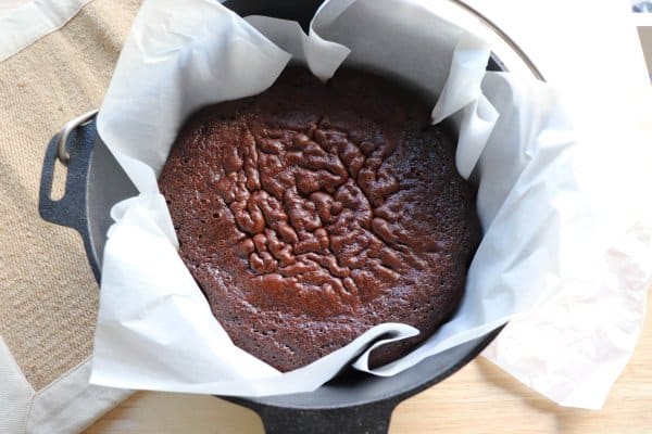 Dutch Oven Chocolate Cake in a parchment paper lined cast iron dutch oven.
