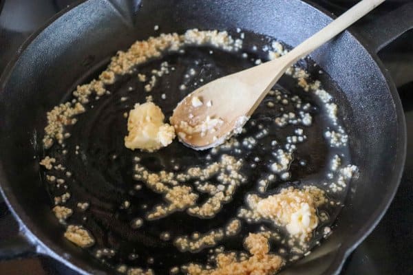 skillet philly cheesesteak recipe Butter and garlic sauteing in a cast iron skillet.