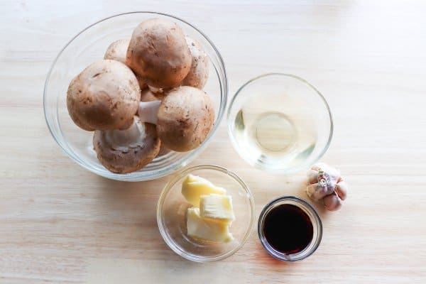 skillet philly cheesesteak recipe Skillet Garlic Mushroom Recipe Ingredients in clear glass bowls on a wooden table.