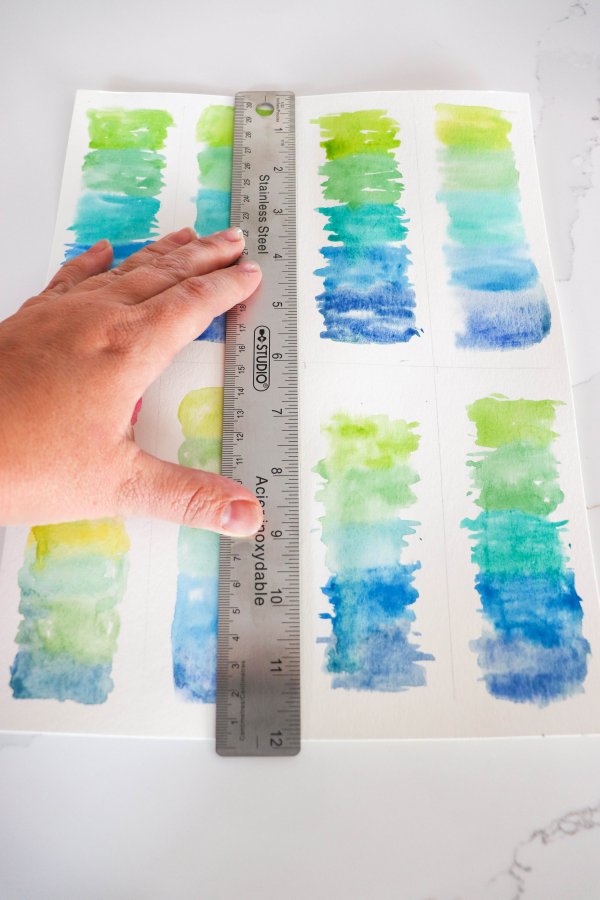 A ruler is used to tear the bookmarks apart along the section lines.
