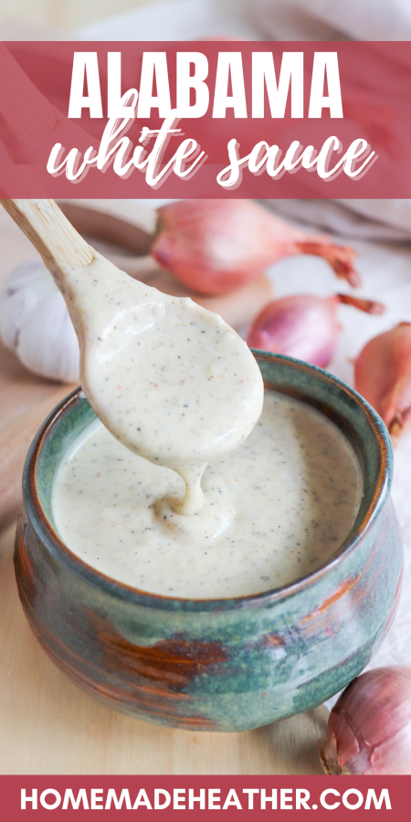 Alabama White Sauce with black pepper flakes in a blue dish with a wooden spoon with a text overlay.