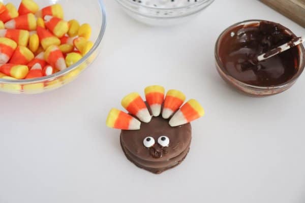 Nutter Butter cookie with candy corn and candy eyes on top.