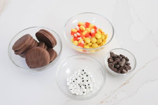 Nutter Butter Turkey Cookie ingredients in clear glass bowls on a white counter.