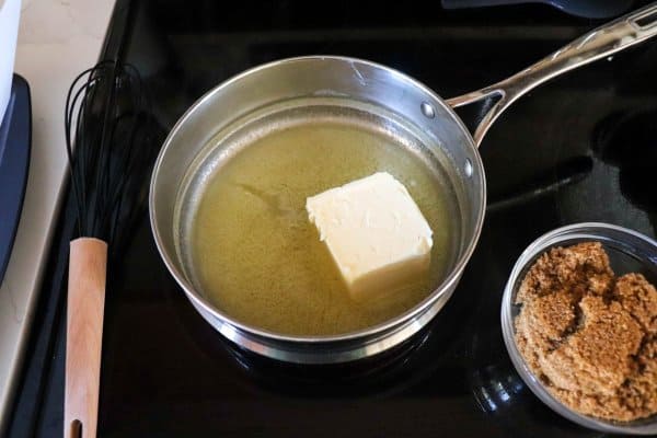 Butter melting in a pot on the stove.