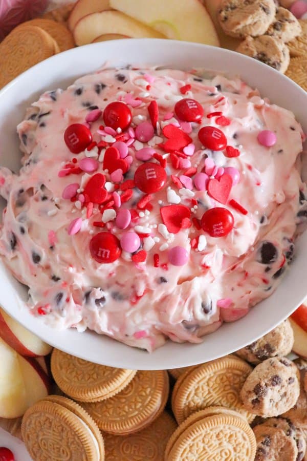 Valentine's Day Dessert Dip with red M&Ms and heart sprinkles.