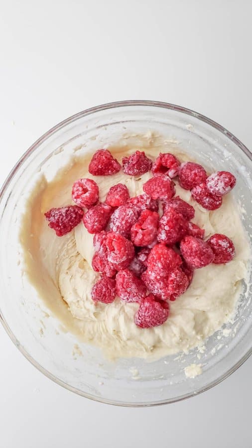 Folding the raspberries into the cake batter.