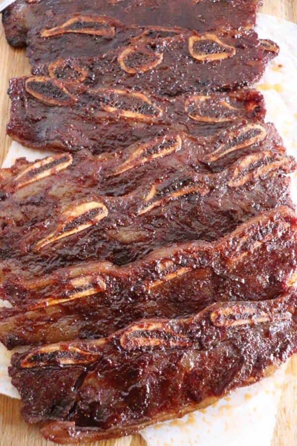 Short ribs on a board after being smoked.