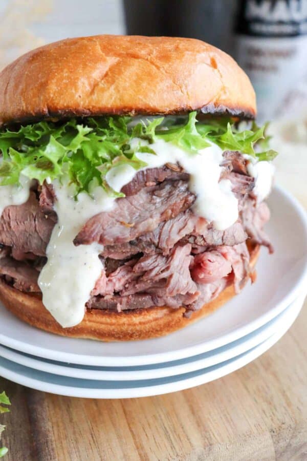 The best roast beef sandwich recipe on a bun with lettuce and garlic aioli.