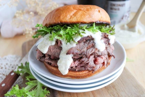 The best roast beef sandwich recipe on a bun with lettuce and garlic aioli.