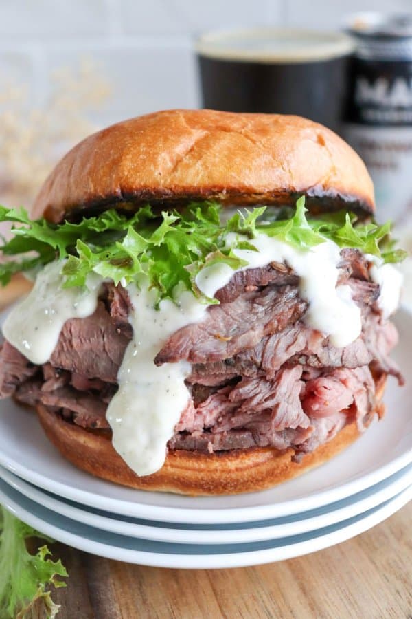 The best roast beef sandwich recipe on a bun with lettuce and garlic aioli.