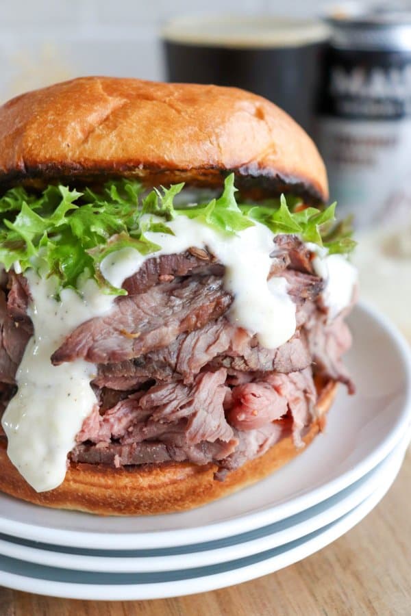 The best roast beef sandwich recipe on a bun with lettuce and garlic aioli.