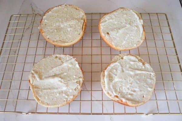 Roast beef sandwich process. spreading garlic aioli on buns.