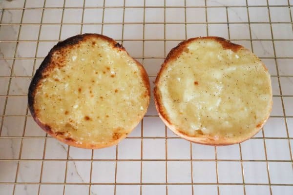 Toasting buns to make roast beef sandwiches.