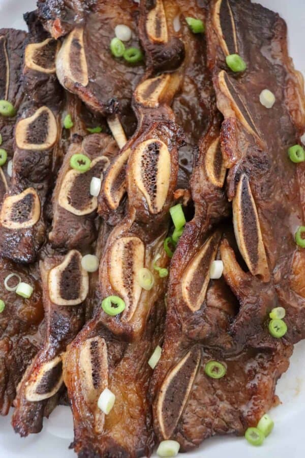 Oven baked spare ribs with green onions on top.