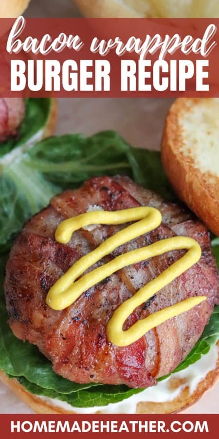 Burger wrapped in bacon with a squiggle of yellow mustard on top on a bed of lettuce with mayo on a toasted white hamburger bun with text overlay.