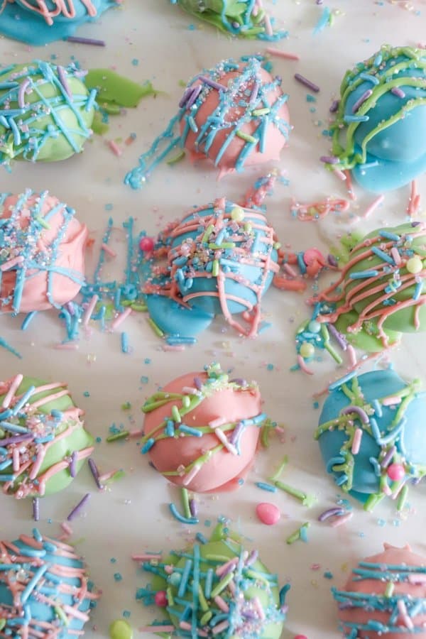 Easter Oreo Cake Balls in a variety of colors on parchment paper.