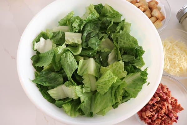 Chopped romaine lettuce in a white bowl.