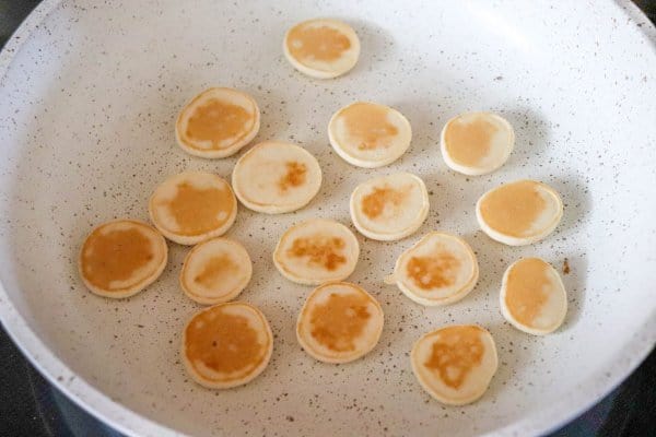 Mini pancakes cooking in frying pan