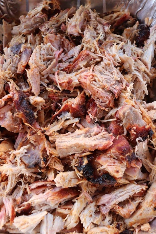 Pulled pork shredded in an aluminum tray.