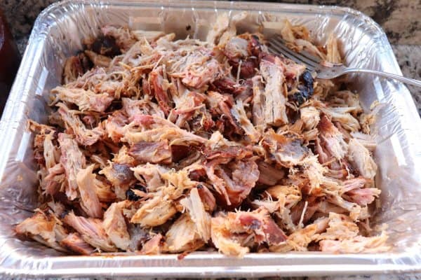Pulled pork shredded in an aluminum tray.