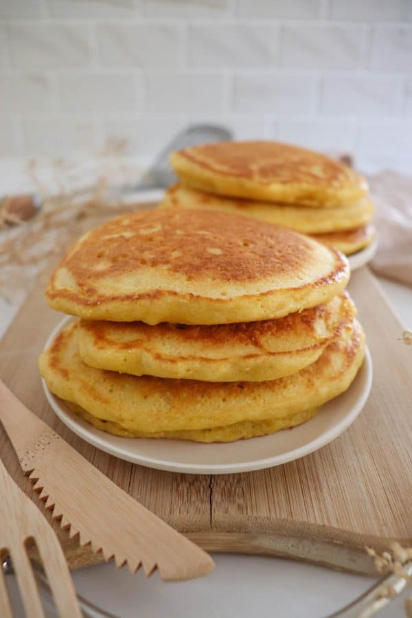 A stack of cornmeal pancakes on a plate.