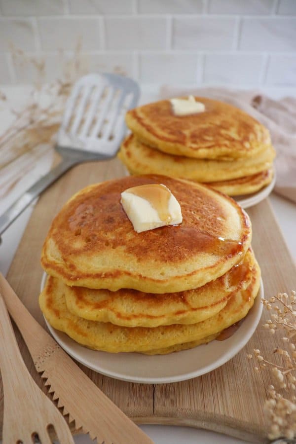 Two stacks of pancakes made with the cornmeal pancake recipe.
