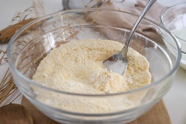 Cornmeal pancake dry ingredients in a glass bowl.