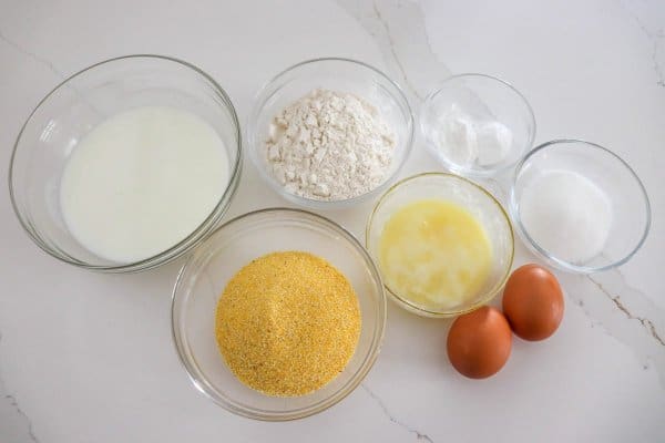 Small glass bowls with the cornmeal pancake ingredients.